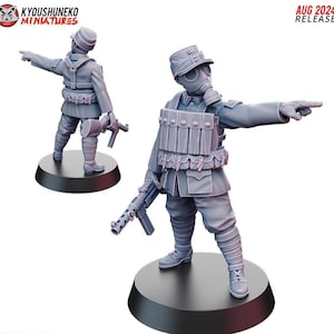 May include: Two gray miniature figurines of soldiers, one wearing a gas mask and the other a helmet, both pointing. They are holding rifles and standing on black circular bases. The text "AUG 2024 RELEASE" is visible.