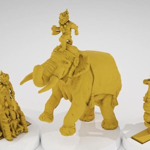 May include: Three mustard-yellow figurines on white pedestals. One is an elephant with a figure riding on top. Another figure stands on a rocky base, and the third is on a decorative base.