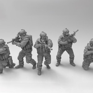 May include: Five grey plastic toy soldiers in military gear holding rifles. The soldiers are posed in different action stances.