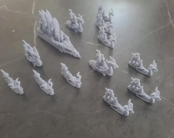 May include: A collection of 14 miniature dragon ships, painted in a light gray color. The ships are made of plastic and have intricate details, including sails, masts, and dragons.