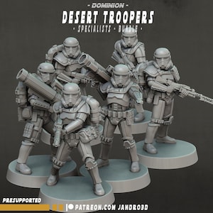 May include: A set of five grey miniature soldier figurines titled Dominion Desert Troopers Specialists Bundle. Each figure wears detailed tactical armor, helmets, and carries various weapons including rifles and large cannons on circular bases.