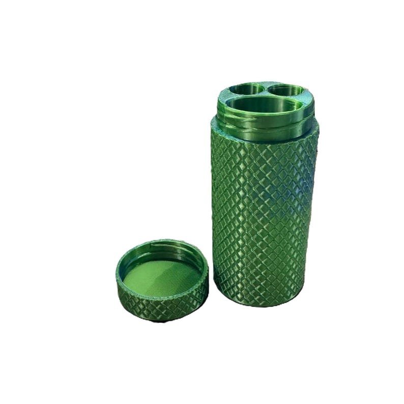 May include: A green metal container with three compartments and a matching lid. The container has a textured diamond pattern.
