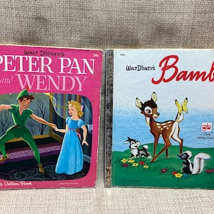 May include: Two vintage Little Golden Books, one featuring Peter Pan and Wendy with a pink cover and the other featuring Bambi with a green cover. Both books have the Walt Disney's logo and the Little Golden Book logo.