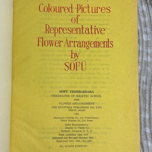 May include: A vintage book page with the title "Coloured Pictures of Representative Flower Arrangements" by SOFU. The text is in red on a yellow background. Details include the publisher, year 1955, and copyright information.