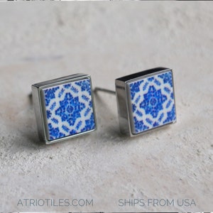 May include: Two square cabinet knobs with a silver finish and a blue and white patterned tile insert.