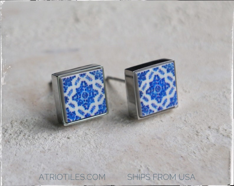 May include: Two square cabinet knobs with a silver finish and a blue and white patterned tile insert.
