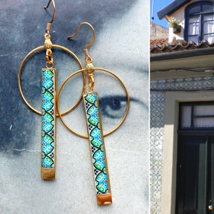 May include: Gold hoop earrings with a blue and green patterned bar pendant. The pattern is reminiscent of traditional Portuguese tilework.