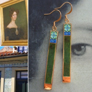 May include: A pair of green and blue tile earrings with gold hooks. The tiles are rectangular and have a geometric pattern.