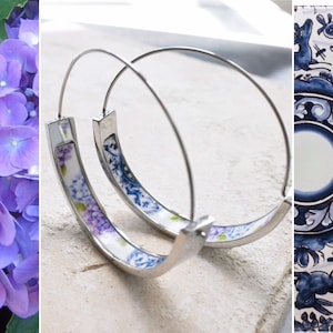 May include: A pair of silver hoop earrings with a blue and white floral design. The earrings are made from recycled materials.