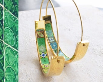 May include: Gold hoop earrings with a colorful patterned design. The pattern features green, blue, and yellow tiles.