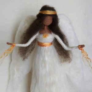 May include: A hand-felted angel doll with long brown hair, a white dress, and gold wings. The angel is wearing a gold crown and has a golden ribbon around its waist.