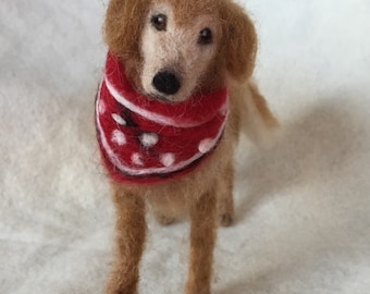 May include: A needle felted golden retriever dog wearing a red and white polka dot bandana.