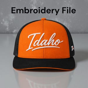 May include: An orange and black trucker hat with the word "Idaho" in white script. The hat has a mesh back and a curved brim. The text "Embroidery File" is at the top of the image.