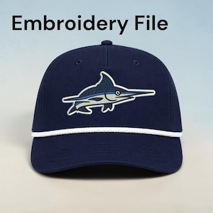 May include: A navy blue baseball cap featuring an embroidered marlin fish graphic in shades of blue, white, and black. The cap includes a white braided cord trim across the base of the crown and the text Embroidery File printed above the cap.