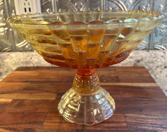 Produced from 1940-1960, this vintage Jeannette Glass Floragold Louisa Pattern Amberina Glass Pedestal Fruit Bowl is a beautiful piece. It h