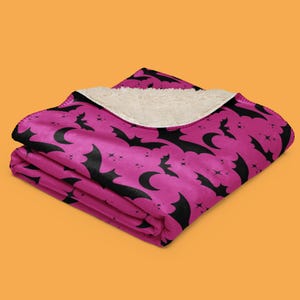 Bats In The Night Sherpa Fleece Blanket. Color: Spooky Sorbet. Halloween Home Decor. Available from HappyGlowLuckyCo.