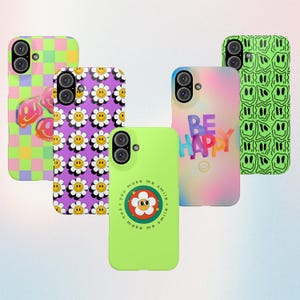 May include: A selection of phone cases with diverse designs. The cases display colourful patterns, including smiley faces, daisies, and the words "BE HAPPY." The cases are in shades of green, purple, pink, and yellow.