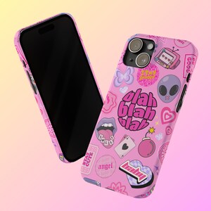 May include: Pink phone case with a variety of colorful stickers, including a butterfly, a heart, a bomb, a tongue, a playing card, a TV, an alien, and the words "blah blah blah".