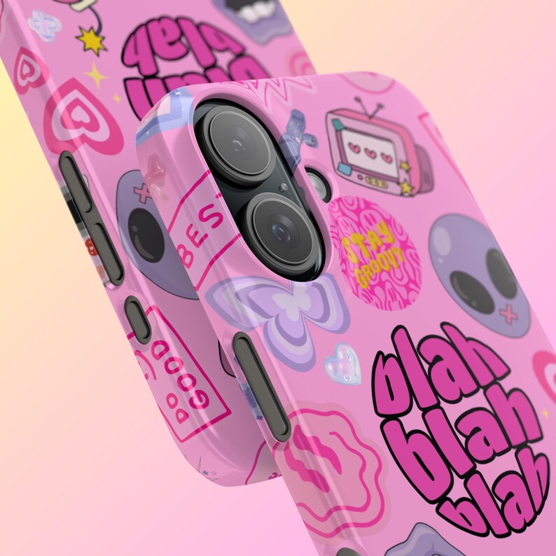 May include: Pink phone case with a variety of colorful stickers and the text "blah blah blah" printed on it.