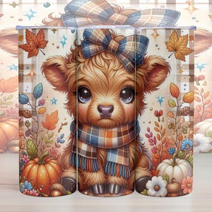 May include: A set of three 20 oz. stainless steel tumblers with a fall-themed design. The tumblers feature a cute cartoon highland cow wearing a plaid scarf and a bow. The background is a plaid pattern with fall leaves and pumpkins.