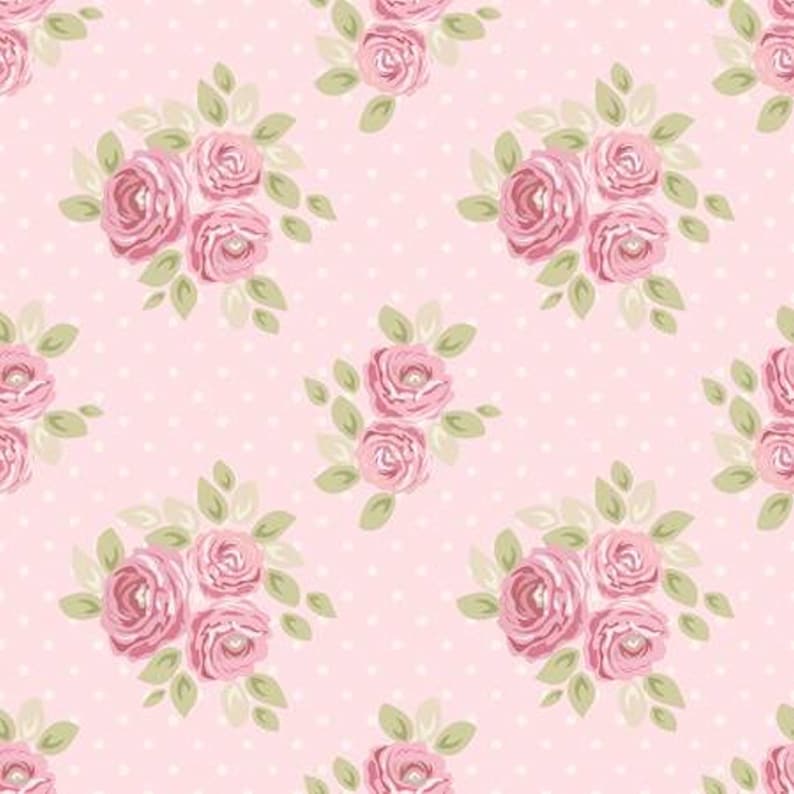 May include: A repeating pattern of pink roses with green leaves on a light pink background with small white polka dots. The floral design features clusters of roses, creating a vintage, romantic aesthetic.