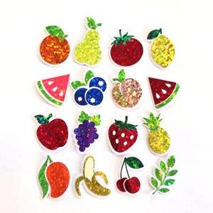 May include: A collection of glittery fruit stickers, including an orange, pear, tomato, lemon, watermelon slice, blueberries, peach, apple, grapes, strawberry, pineapple, mango, banana, cherries, and a leafy sprig. Each sticker has a white border.