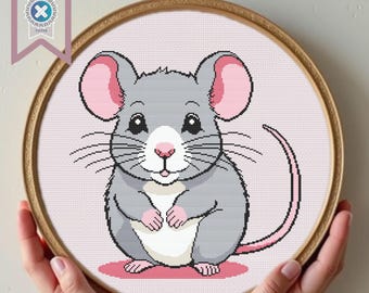 May include: A cute cartoon gray mouse with pink ears and a white belly. The mouse is smiling and has a pink nose. The mouse is sitting on a pink background.