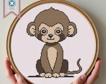 May include: A cross-stitch pattern of a brown monkey with big eyes and a tail. The monkey is sitting on a white background.