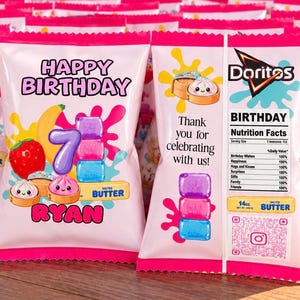 May include: A custom Doritos-style snack bag featuring a pink and white design with the text Happy Birthday, the number 7, and the name Ryan. Graphics include a strawberry, banana, and cute dumplings, with a nutrition facts label and 14 oz. text.