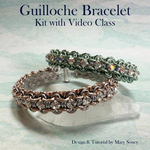 May include: Two handmade guilloche bracelets with sparkling crystal accents. One bracelet is silver and copper-toned, the other is green. The bracelets are displayed on a clear, crystalline surface. Text reads "Guilloche Bracelet Kit with Video Class."