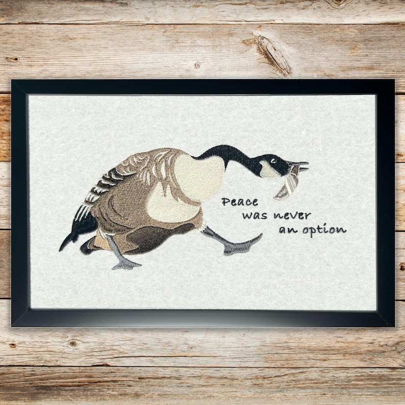 Silly Goose wall art with embroidered Canadian goose carrying a knife – Peace Was Never an Option.