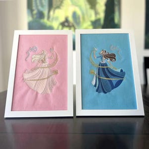 2000s nostalgia wall decor with girlypop inspired princess and pauper embroidery in a white frame.