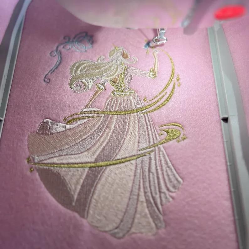 Close-up of the pink and blue butterfly details in the 2000s nostalgia princess embroidery design.