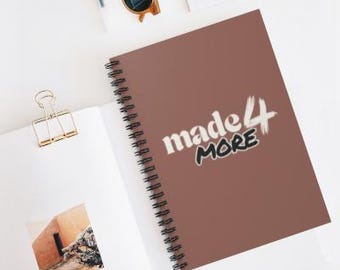 May include: A brown spiral notebook with the text "made 4 more" in white and black lettering.