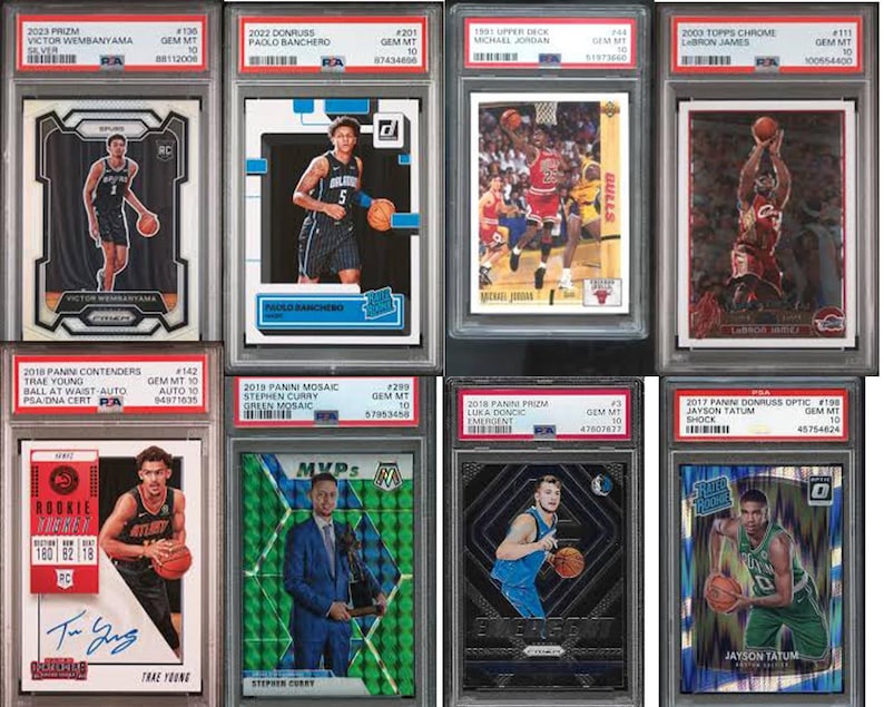 May include: A collection of ten graded sports trading cards featuring basketball players. The cards are encased in plastic holders with a white background and black borders. The cards feature players such as Victor Wembanyama, Paolo Banchero, Michael Jordan, LeBron James, Trae Young, Stephen Curry, Luka Doncic, and Jayson Tatum.