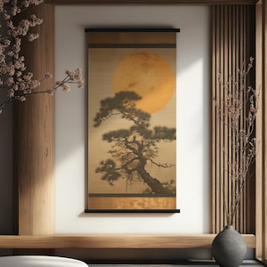 May include: A framed Japanese-style scroll painting featuring a large, golden sun and a silhouetted pine tree. The artwork is displayed in a minimalist interior with wooden accents and a decorative vase.
