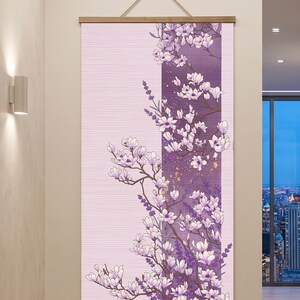 May include: A vertical wall hanging featuring a light pink background with a central dark purple panel. The artwork displays white and light purple magnolia blossoms on brown branches, accented with small gold flecks and lavender sprigs.