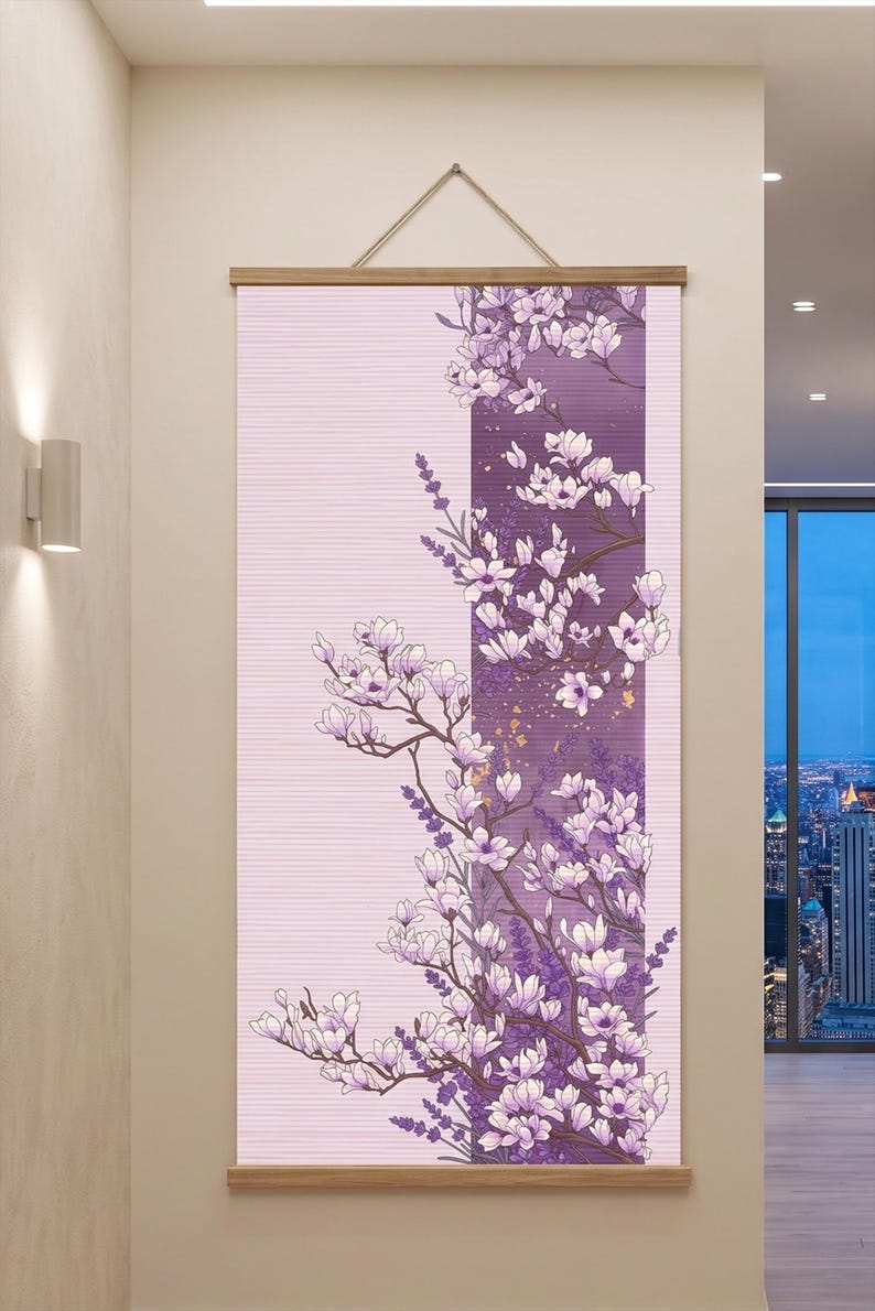 May include: A vertical wall hanging featuring a light pink background with a central dark purple panel. The artwork displays white and light purple magnolia blossoms on brown branches, accented with small gold flecks and lavender sprigs.