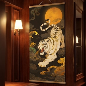 May include: A decorative wall hanging featuring a white tiger with gold accents, set against a dark background with a full moon and stylized clouds. The artwork is displayed in a wooden frame, adding a touch of elegance.