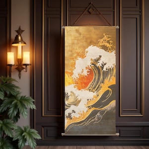May include: A vertical wall hanging featuring a Japanese-style wave design. The artwork uses a palette of gold, orange, and white, with a large wave dominating the composition. The scroll is suspended by a brown leather cord.