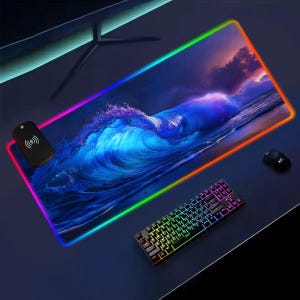 May include: A large rectangular mouse pad with a vibrant ocean wave design. The pad has a colorful LED border and includes a wireless remote, a keyboard, and a mouse. The keyboard and border have rainbow-colored lights.
