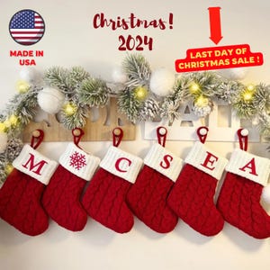 May include: Red and white Christmas stockings spelling out "M-C-S-E-A" hang from a garland. The stockings have a cable knit design and white cuffs. The image includes the text "Christmas! 2024" and "Last Day of Christmas Sale!"