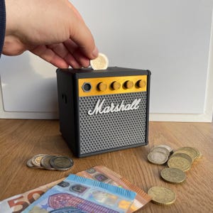 Tippot rock-'n-roll-bar en muziekwinkel, motiverend spaarvarken, aanpasbare gepersonaliseerde klassieke versterker, opvallende muzikale spaarpot