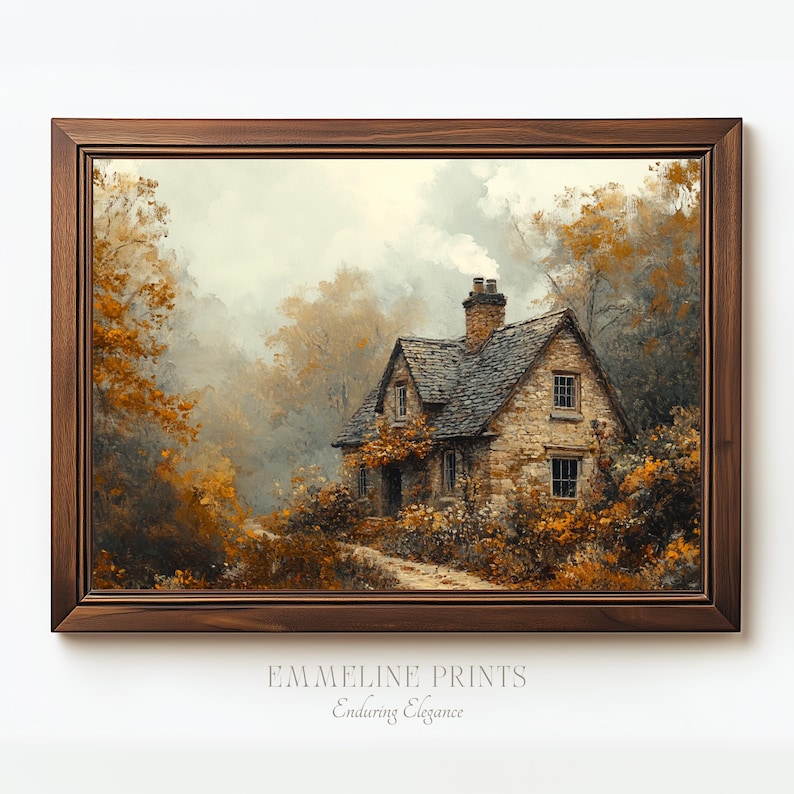 May include: A framed print of a stone cottage nestled among trees with autumn foliage. The artwork features a warm color palette of browns, oranges, and greens, with the text "EMMELINE PRINTS" and "Enduring Elegance" at the bottom.