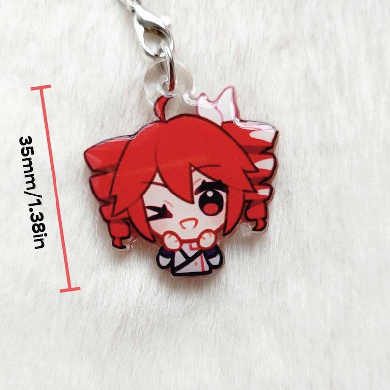 May include: A red anime-style charm with a winking character. The charm is 1.38 inches (35mm) in height and features a silver clasp. The character has red hair and is wearing a white and blue outfit.
