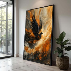 May include: Large framed art print featuring a stylized black bird with outstretched wings against a fiery orange and gold background. The artwork has a dramatic, abstract style, with a black frame and a modern aesthetic.
