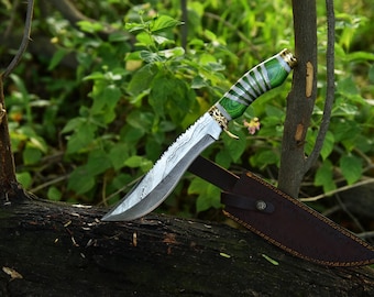 May include: A hunting knife with a green and white handle and a leather sheath. The blade is made of Damascus steel and has a serrated edge.