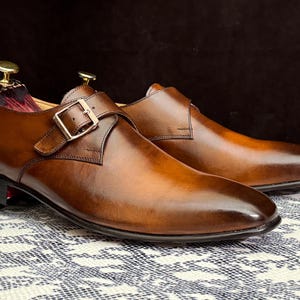 Handmade men's brown single monk strap dress shoes, crafted from premium cowhide leather with Goodyear welt construction, bespoke footwear for timeless style and durability