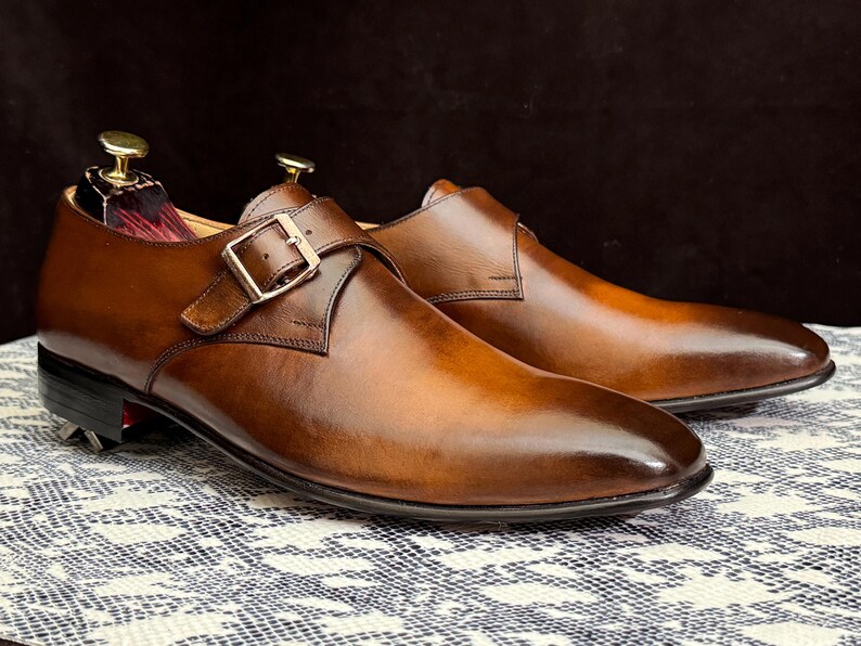 Handmade men's brown single monk strap dress shoes, crafted from premium cowhide leather with Goodyear welt construction, bespoke footwear for timeless style and durability