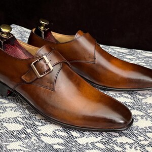 Handmade men's brown single monk strap dress shoes, crafted from premium cowhide leather with Goodyear welt construction, bespoke footwear for timeless style and durability